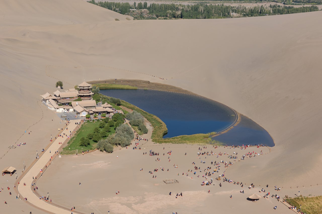 Crescent Lake, pavilion roofs and the Mingsha sand dunes near Dunhuang