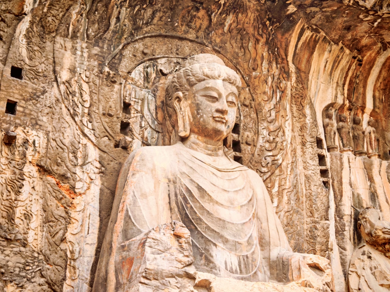 The monumental Buddha and surrounding rock carvings at Longmen Grottoes in Luoyang