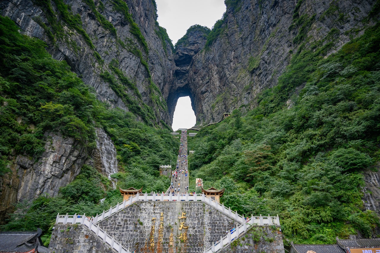 The steep stairway rising between cliffs to the opening of Tianmen Cave